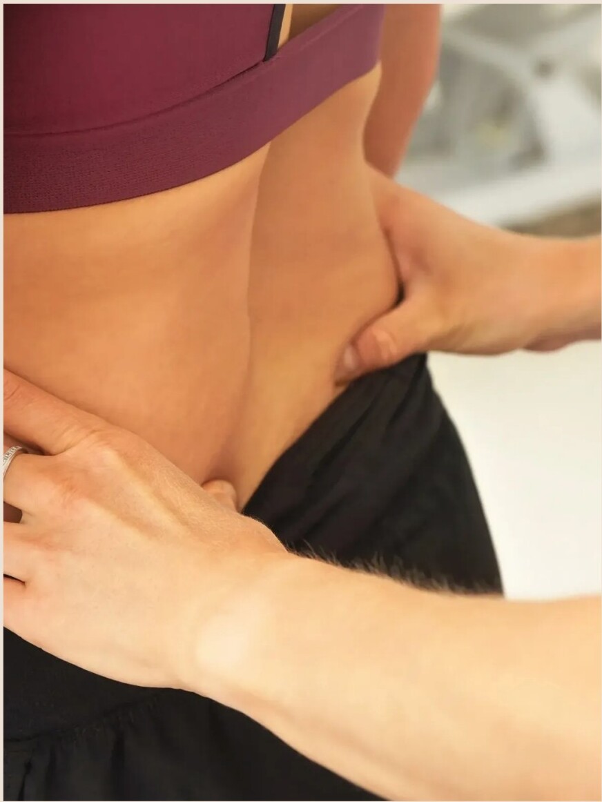 Chiropractor adjusting a patient's lower back